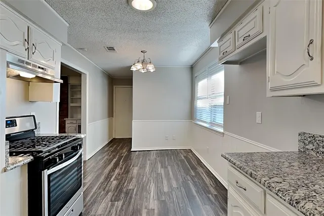 a kitchen with a sink and wooden floor