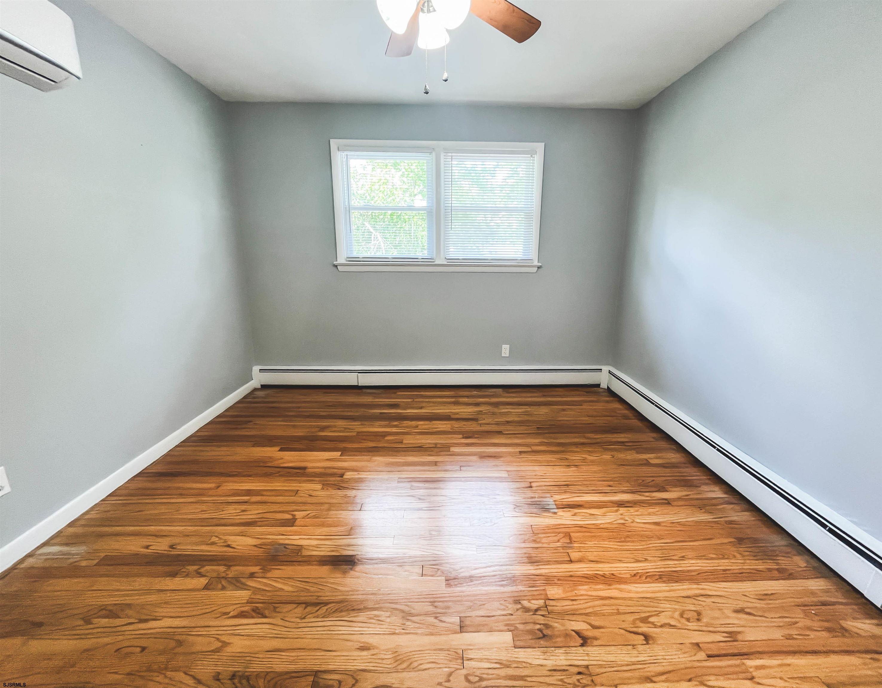 518 Delaware Avenue Absecon, NJ 08201 - Photo 16 of 38 a view of empty room with window and wooden floor