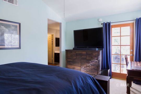 809 Charles Court Ridgecrest, CA 93555 - Photo 19 of 33 a bedroom with a bed and a flat screen tv