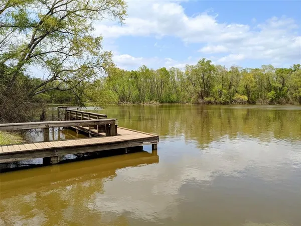a view of a lake with houses in the back