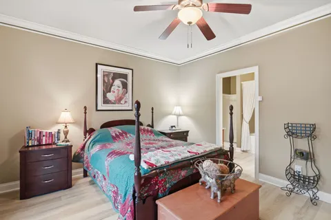 a bedroom with a bed and a window with a bookshelf