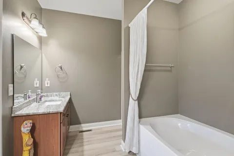 a en suite bathroom with double vanity sinks and a mirror