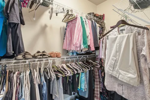 a view of a hallway with bedroom and wooden floor
