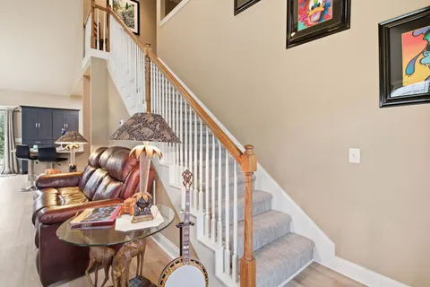 a view of a hallway that has closet with wooden floor