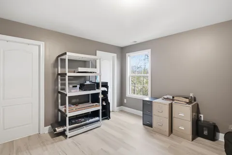 a view of a workspace with furniture and a window