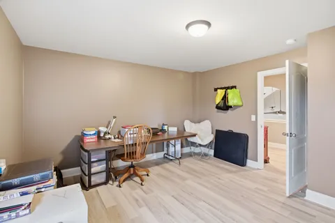 a view of a patio with table and chairs with wooden fence and floor