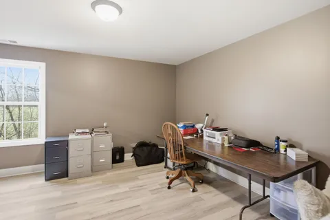 a view of a patio with a dining table and chairs with wooden fence