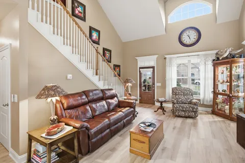 a kitchen with stainless steel appliances kitchen island granite countertop a refrigerator a stove a sink dishwasher with a dining table and chairs