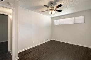 2900 Cole Street, Unit 307 Austin, TX 78705 - Photo 14 of 20 an empty room with a chandelier fan and wooden floor