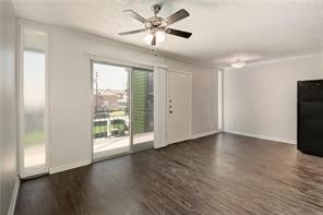 2900 Cole Street, Unit 307 Austin, TX 78705 - Photo 3 of 20 a view of an empty room with wooden floor and a window