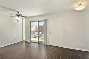 a view of a room with wooden floor and windows