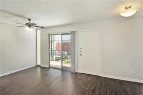 2900 Cole Street, Unit 307 Austin, TX 78705 - Photo 6 of 20 wooden floor in an empty room with a window