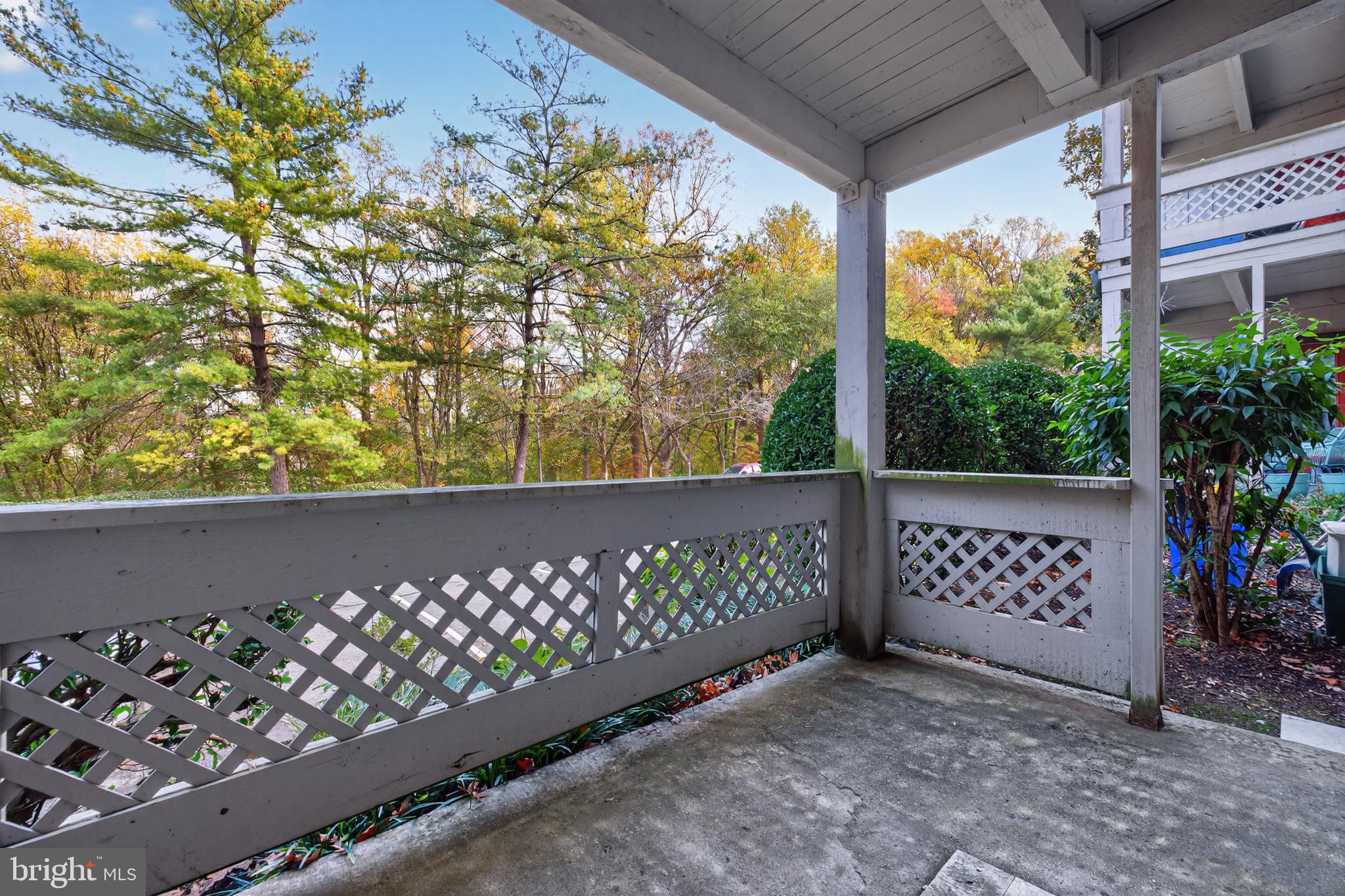 910 Windbrooke Drive, Unit 910 Gaithersburg, MD 20879 - Photo 13 of 20 Serene porch with lush greenery view.