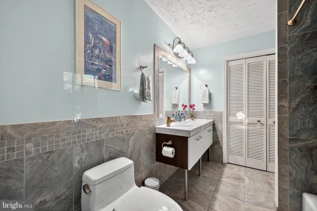 a bathroom with a toilet sink and mirror