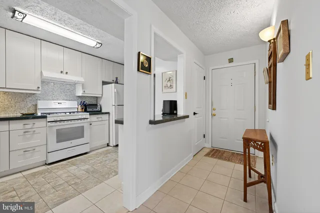 a kitchen with stainless steel appliances a refrigerator sink and cabinets