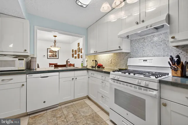 a kitchen with cabinets appliances and a sink