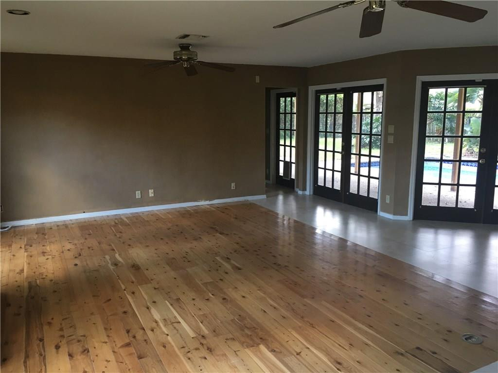1498 Southwest 19th Street Boca Raton, FL 33486 - Photo 7 of 13 an empty room with wooden floor and windows
