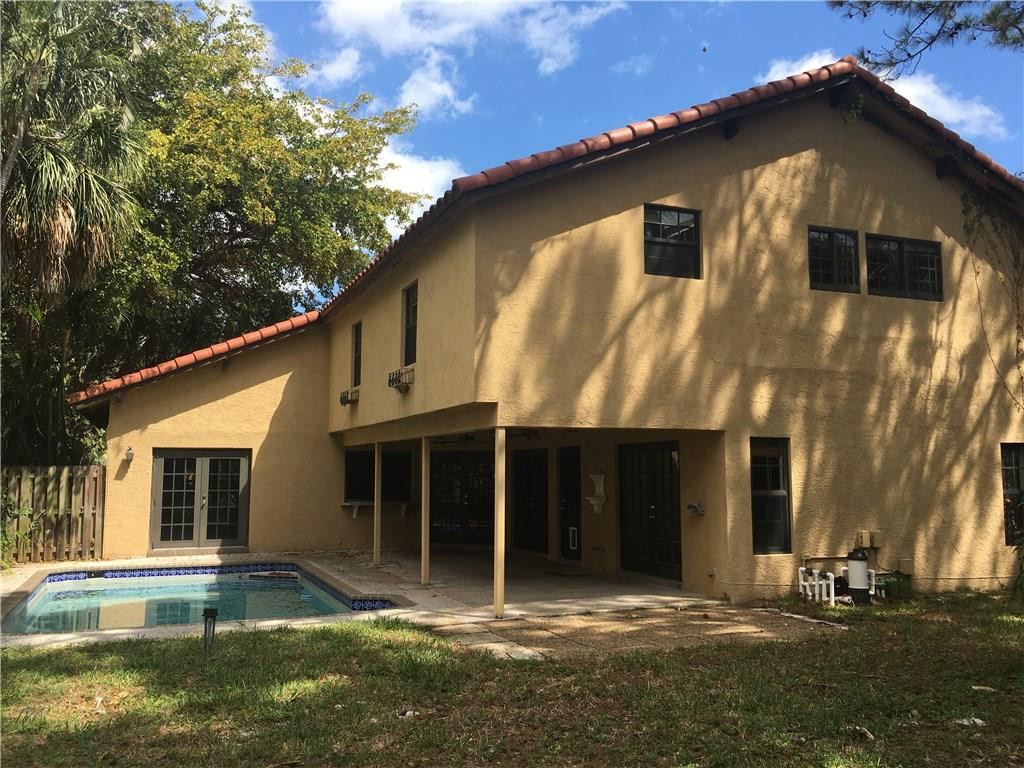 1498 Southwest 19th Street Boca Raton, FL 33486 - Photo 10 of 13 a front view of a house with a yard