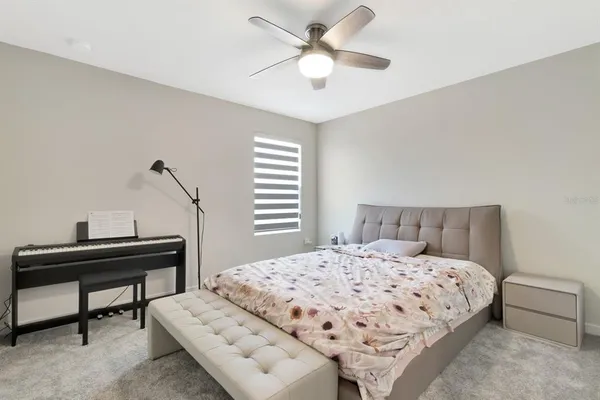 a bedroom with a bed and a desk
