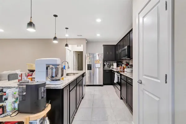 a kitchen with kitchen island a sink appliances and cabinets