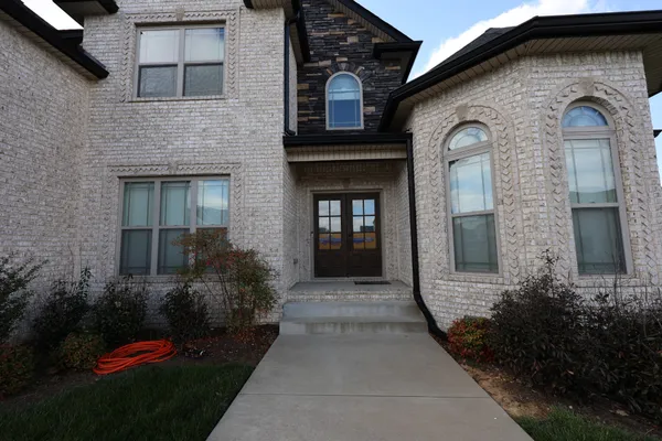 a front view of a house with garden