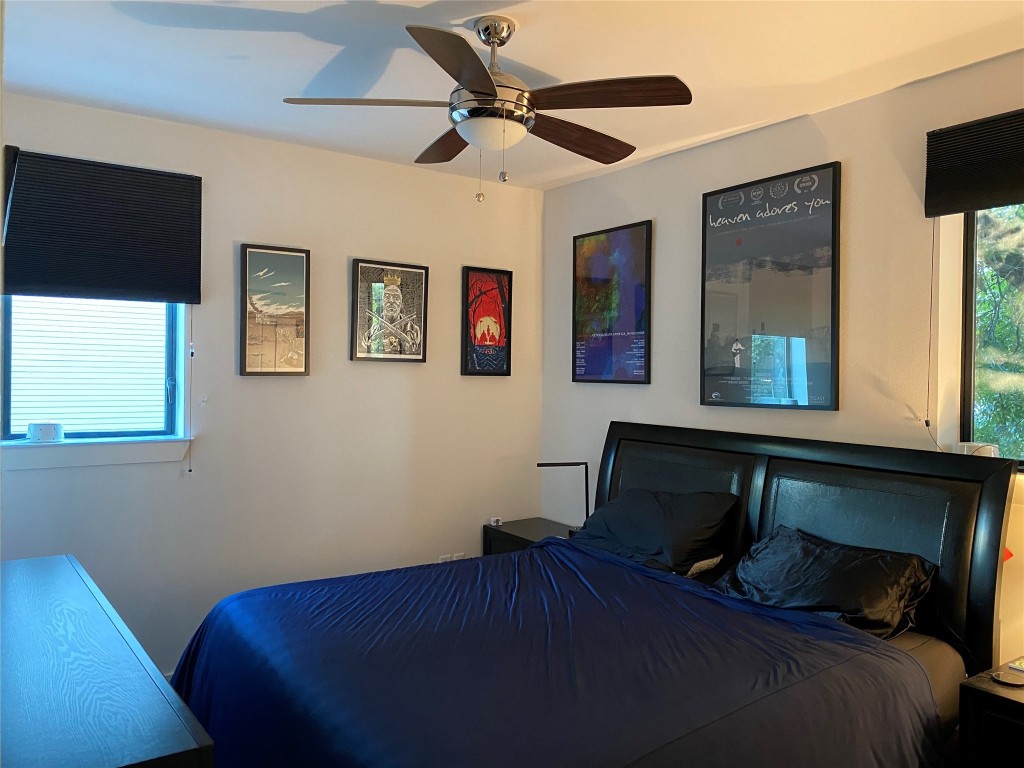 1615 East 7th Street, Unit 304 Austin, TX 78702 - Photo 5 of 12 a bedroom with a bed and wooden floor