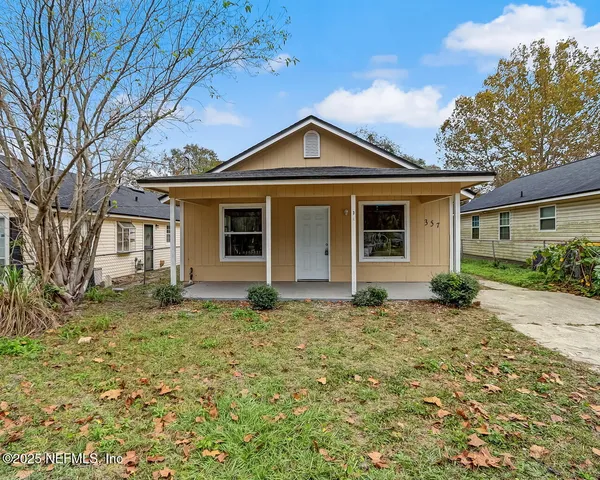 a house that has a large tree in front of it