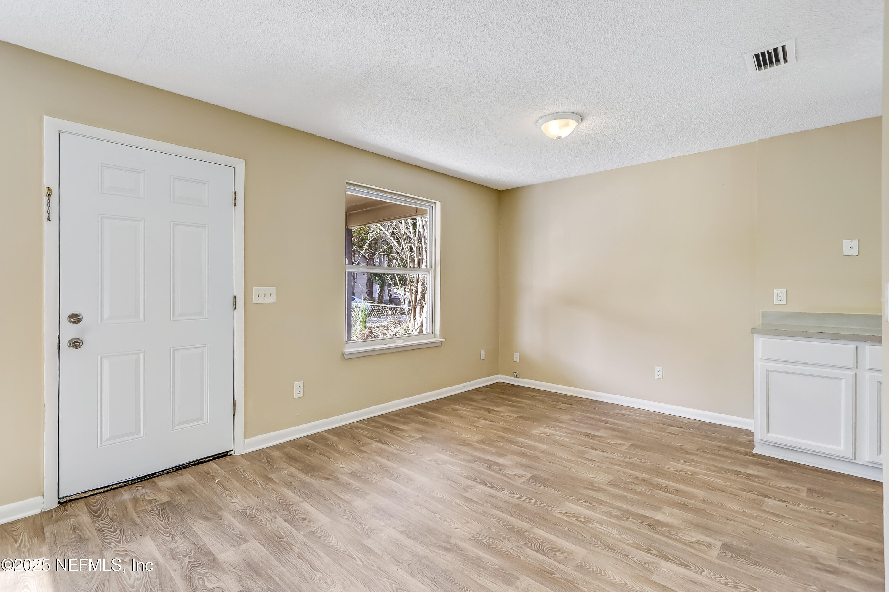 357 Smith Street Jacksonville, FL 32204 - Photo 5 of 26 a view of an empty room with window and wooden floor