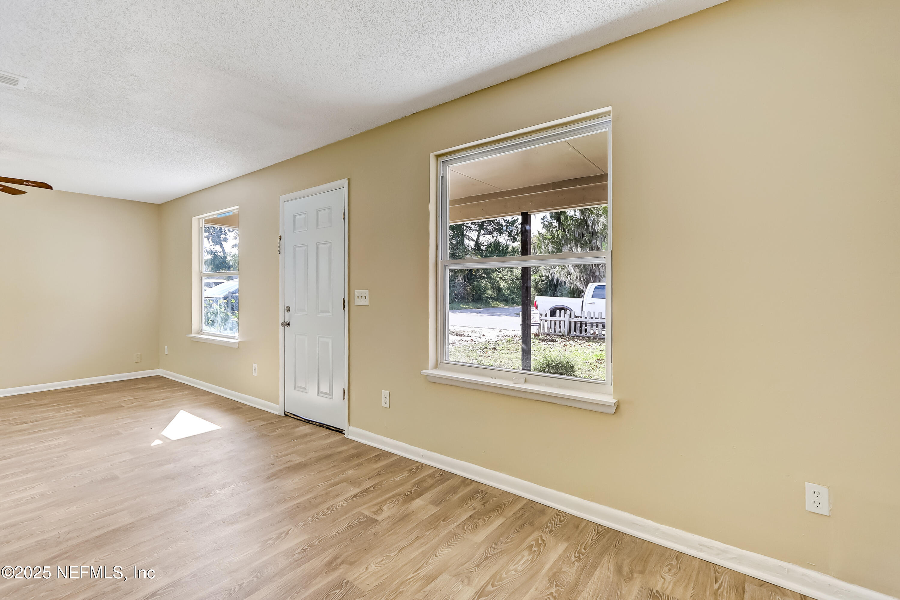 357 Smith Street Jacksonville, FL 32204 - Photo 7 of 26 an empty room with wooden floor and windows