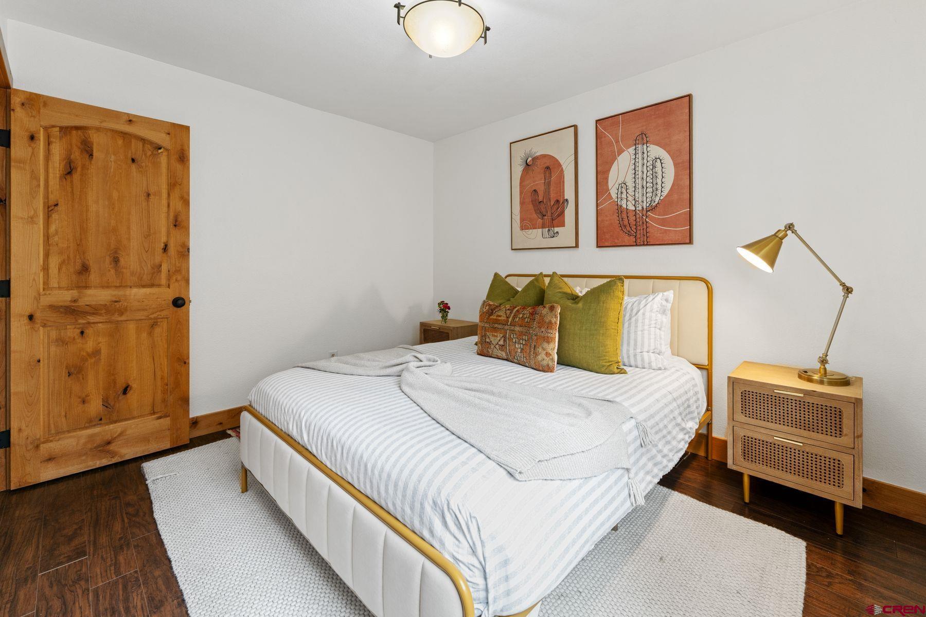 31 Castle Road, Unit 1 Crested Butte, CO 81225 - Photo 19 of 34 a bedroom with a bed and wooden floor