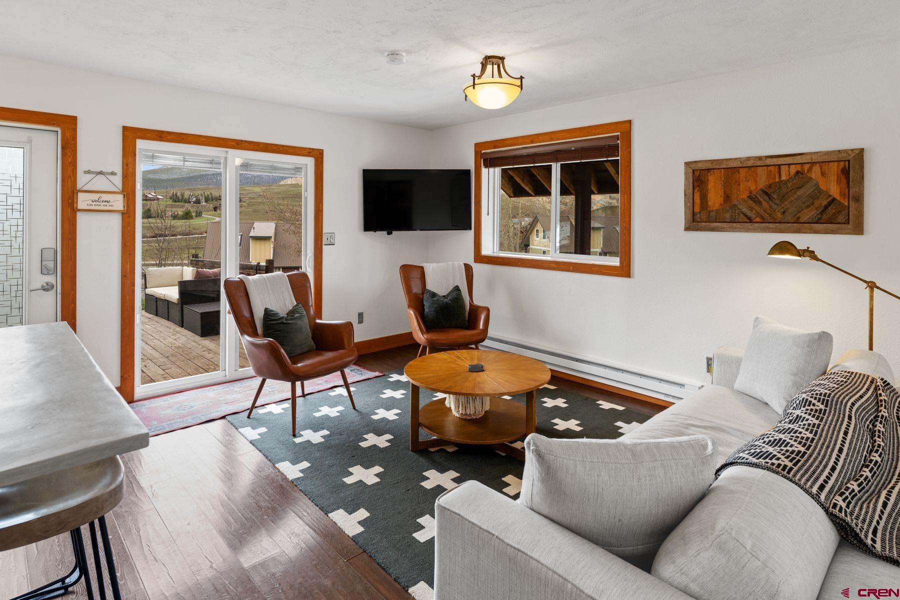 31 Castle Road, Unit 1 Crested Butte, CO 81225 - Photo 2 of 34 a living room with furniture and a flat screen tv