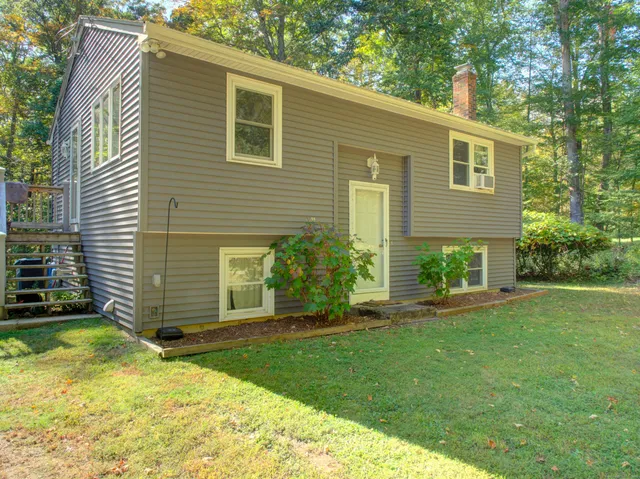 a view of a house with a yard and plants
