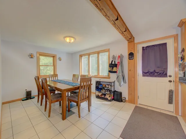 a view of a dining room with furniture and a window
