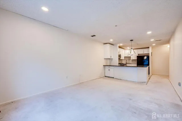 a view of kitchen and a refrigerator