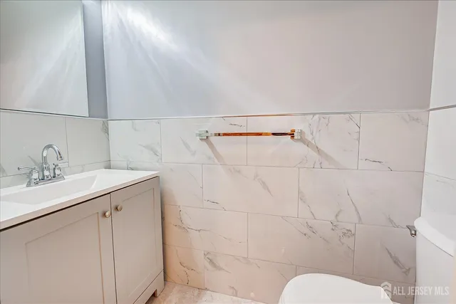 a bathroom with a sink mirror vanity and toilet