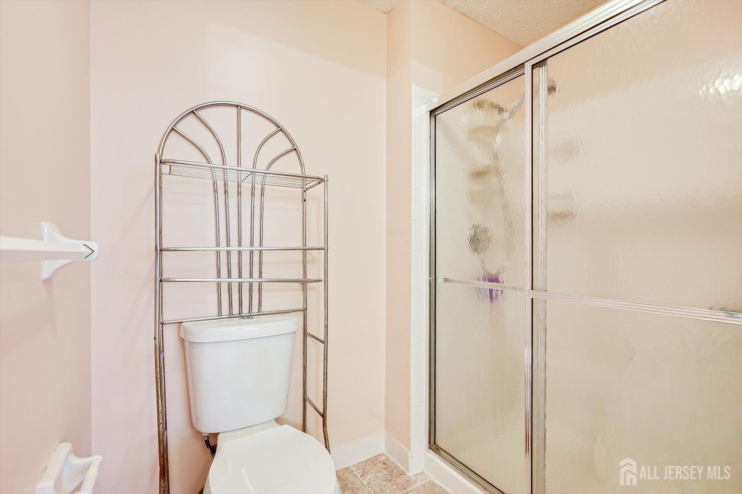 10 Guisborough Way Edison, NJ 08820 - Photo 22 of 27 a bathroom with a toilet a sink and shower