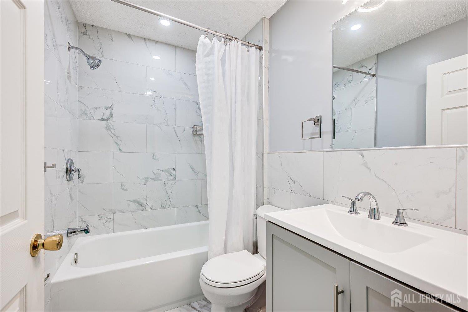 10 Guisborough Way Edison, NJ 08820 - Photo 26 of 27 a bathroom with a sink toilet and shower