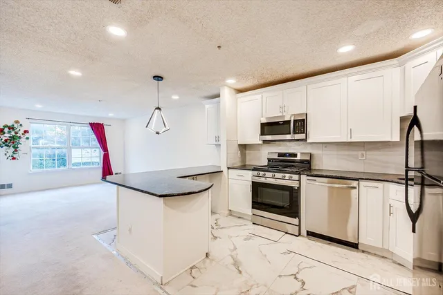a kitchen with a sink stainless steel appliances and cabinets