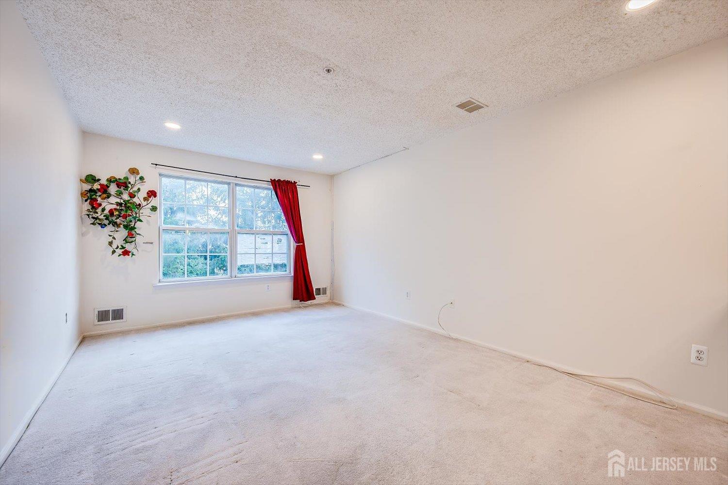 10 Guisborough Way Edison, NJ 08820 - Photo 10 of 27 a view of an empty room with a window