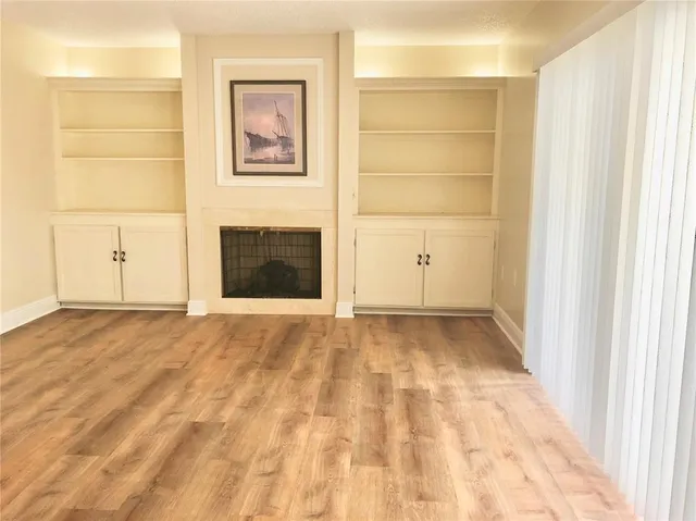 a view of an empty room with a fireplace