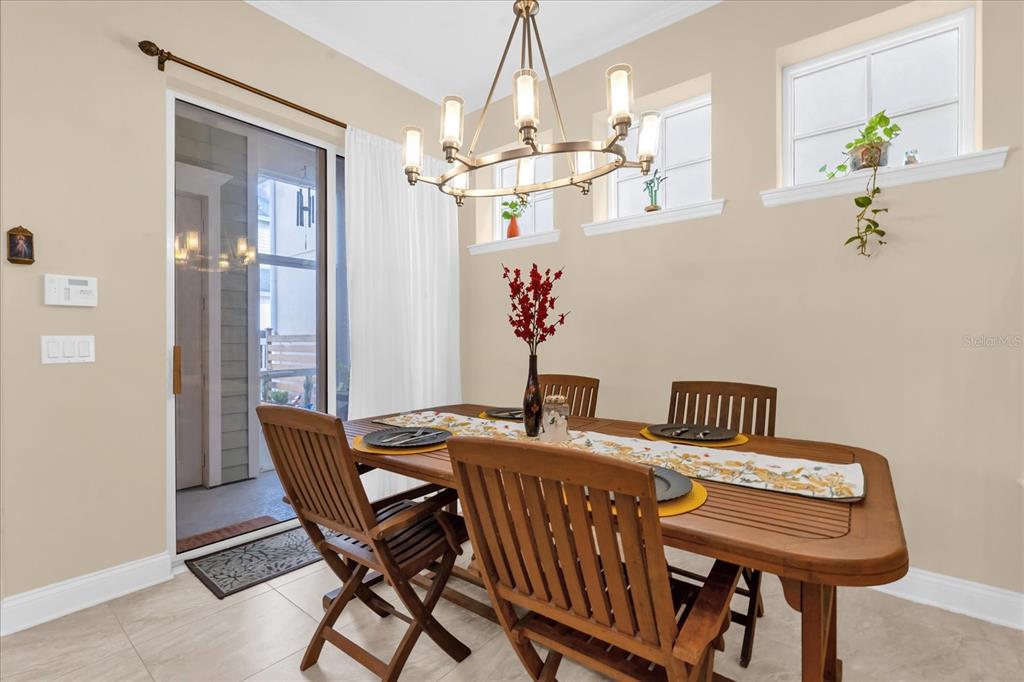 1547 Resolute Street Celebration, FL 34747 - Photo 15 of 40 a view of a dining room with furniture a chandelier and wooden floor