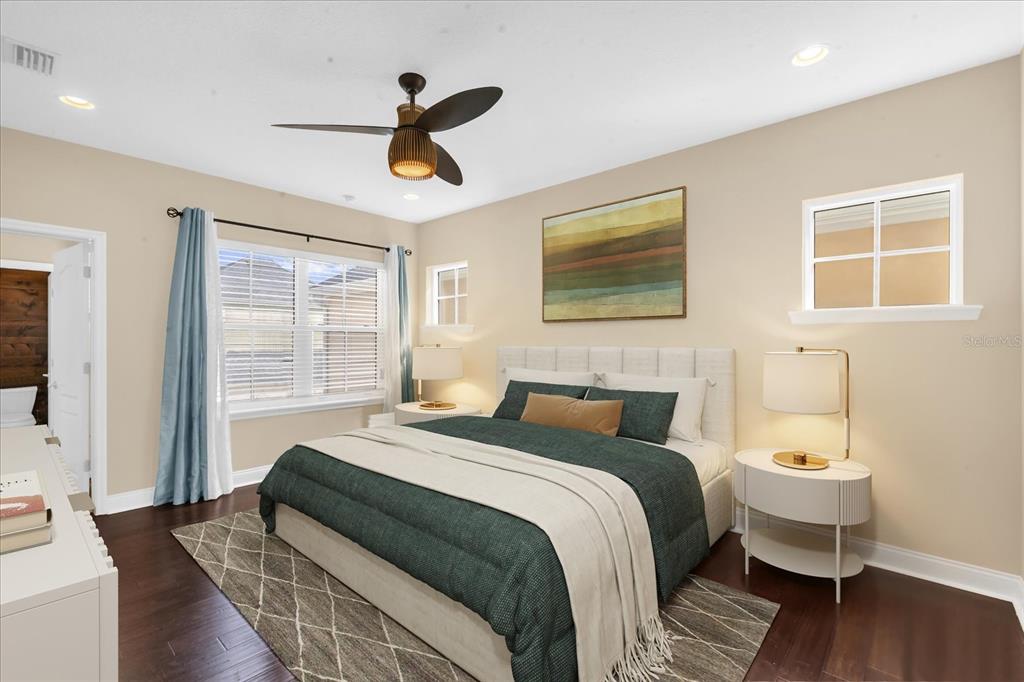 1547 Resolute Street Celebration, FL 34747 - Photo 17 of 40 a bedroom with a bed and wooden floor