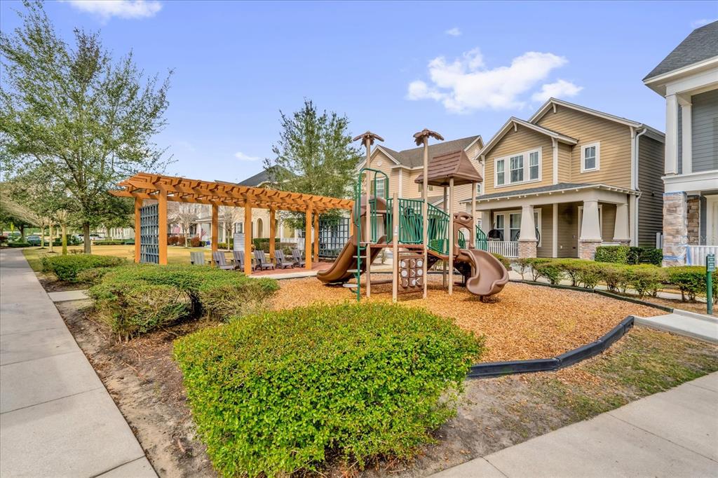 1547 Resolute Street Celebration, FL 34747 - Photo 4 of 40 a view of a white house with a yard table and chairs