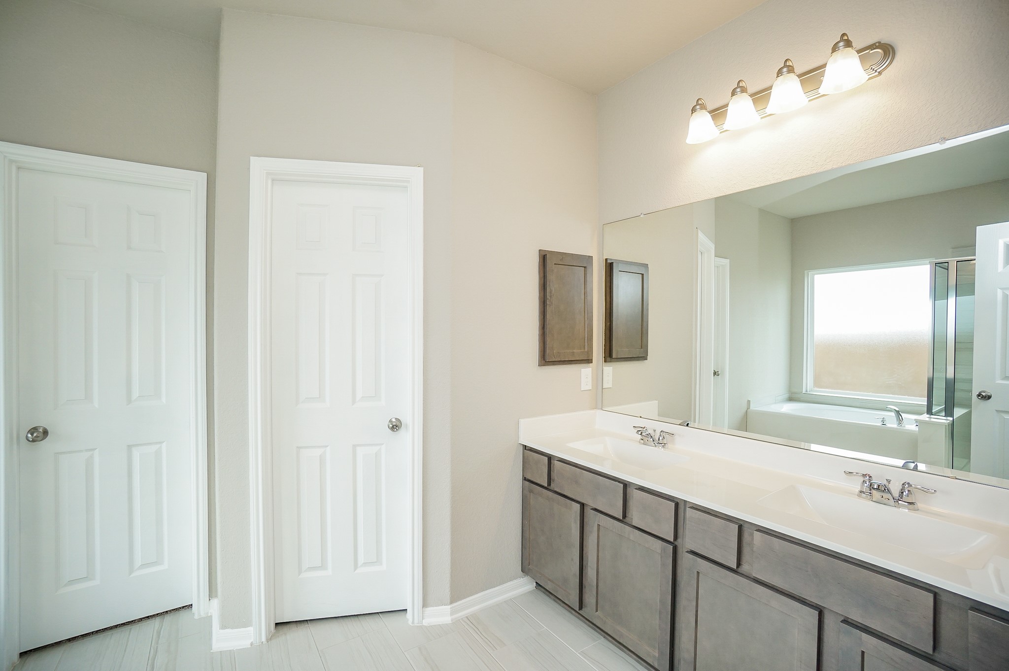 5463 Grand View Drive Fulshear, TX 77423 - Photo 16 of 32 a bathroom with a double vanity sink and a mirror