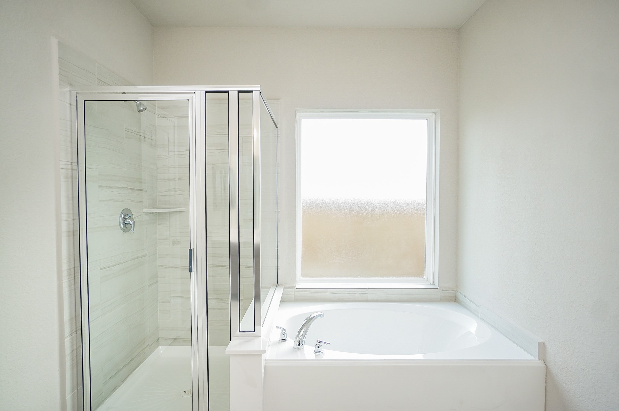 5463 Grand View Drive Fulshear, TX 77423 - Photo 17 of 32 a bathroom with a bathtub and a shower