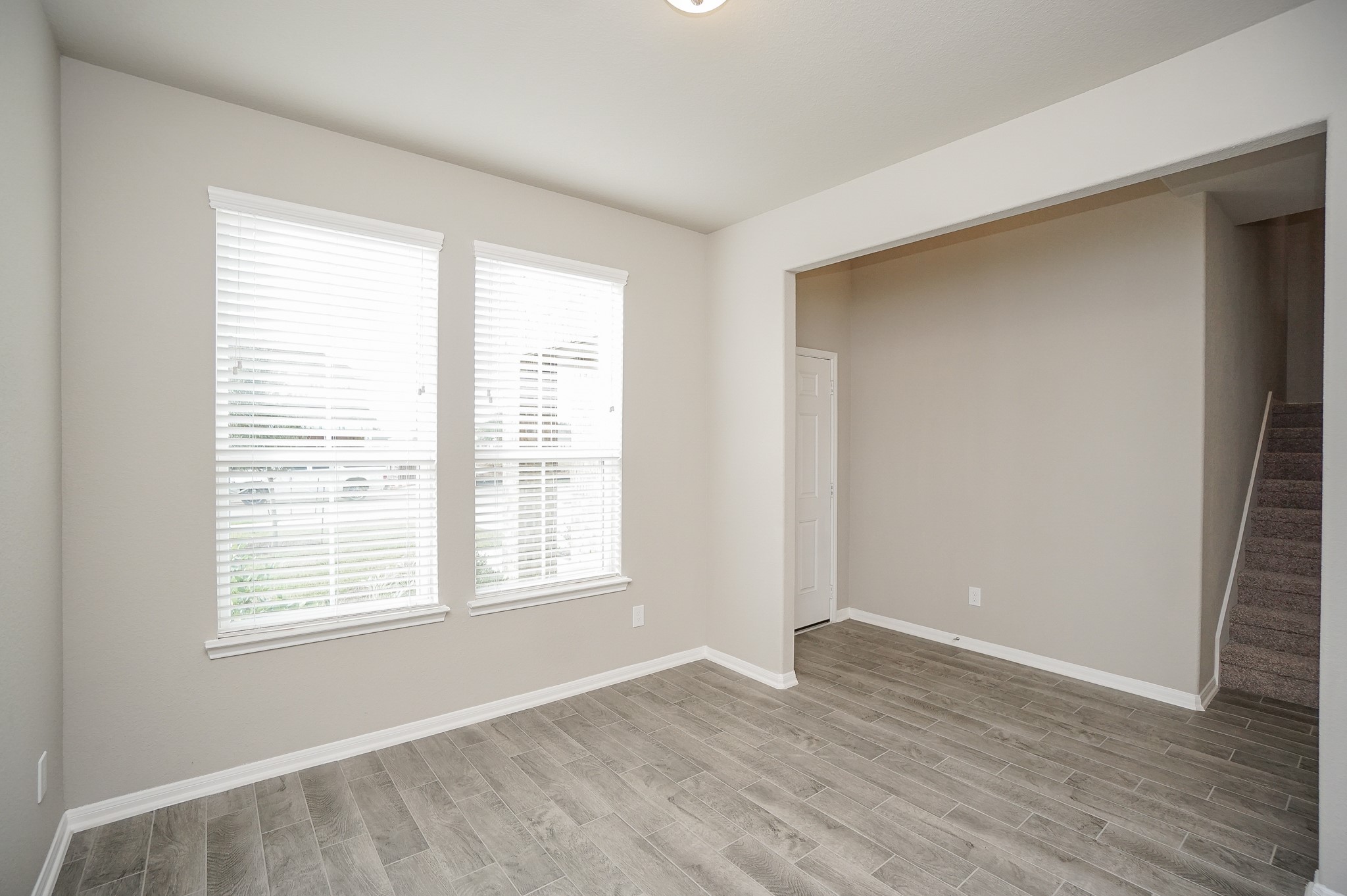 5463 Grand View Drive Fulshear, TX 77423 - Photo 3 of 32 a view of an empty room with wooden floor and a window