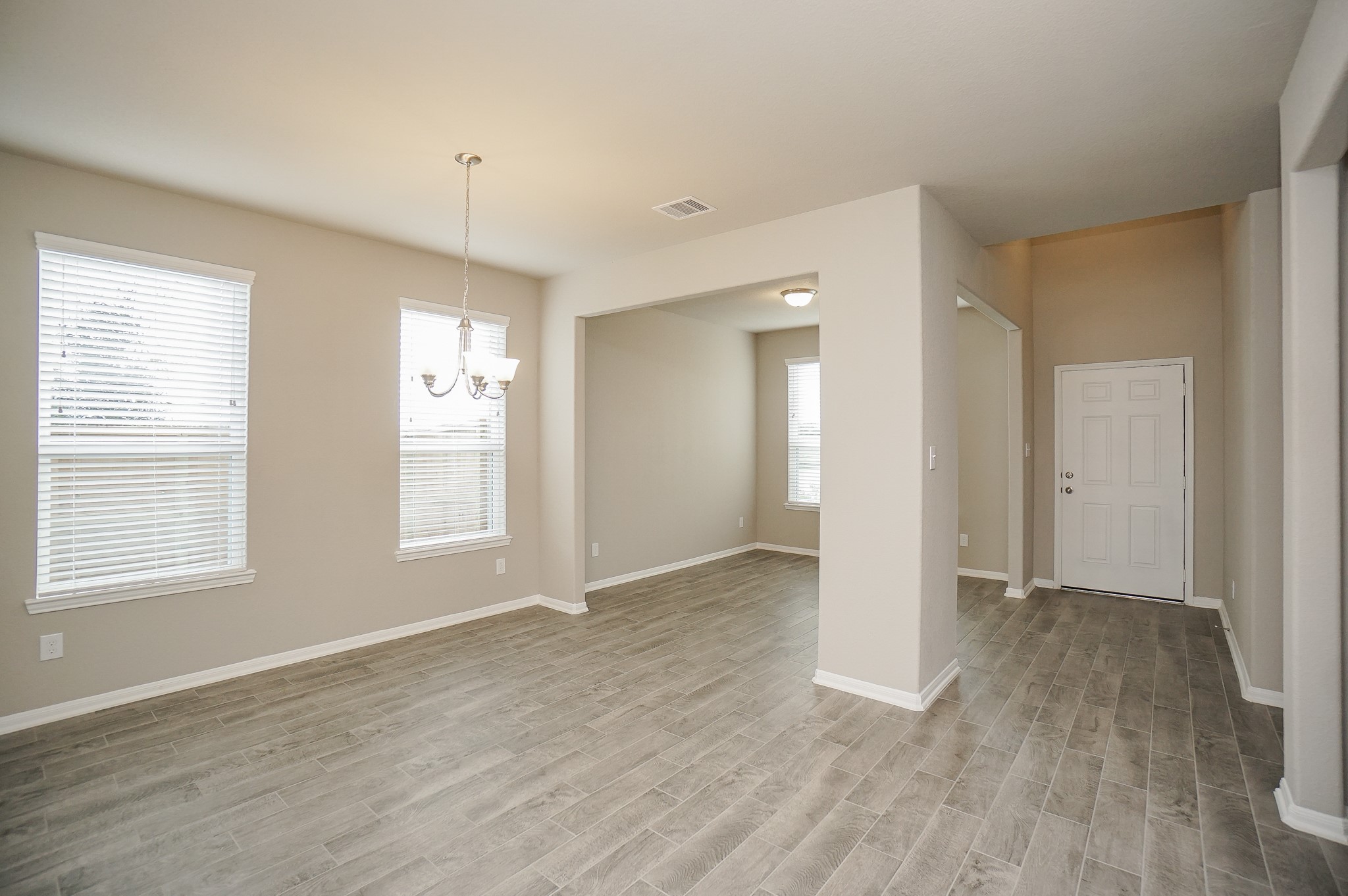 5463 Grand View Drive Fulshear, TX 77423 - Photo 4 of 32 an empty room with wooden floor and windows