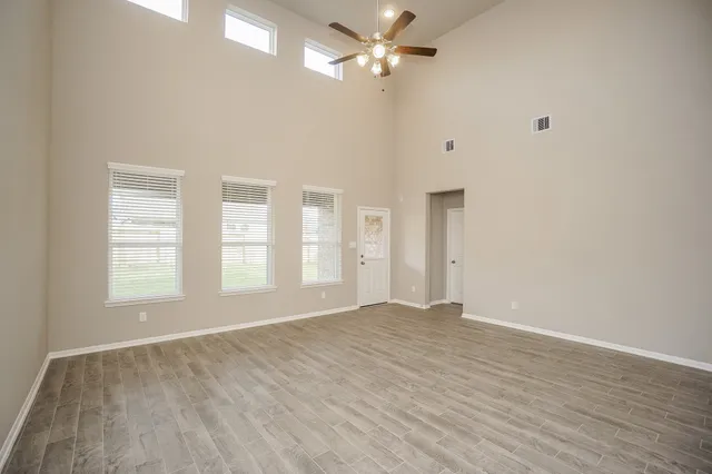 wooden floor in an empty room with a window