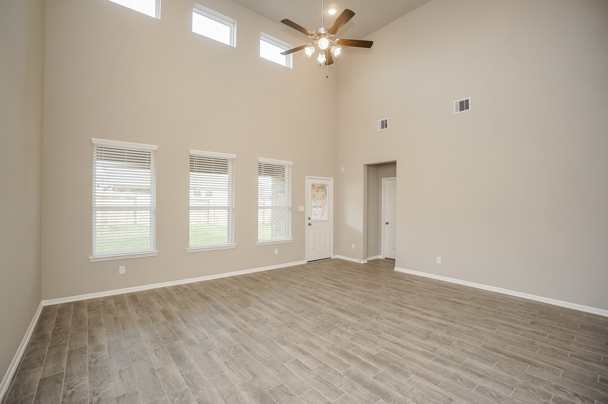 5463 Grand View Drive Fulshear, TX 77423 - Photo 5 of 32 wooden floor in an empty room with a window
