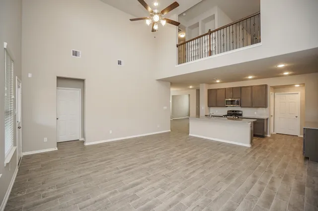 a view of kitchen with refrigerator and window